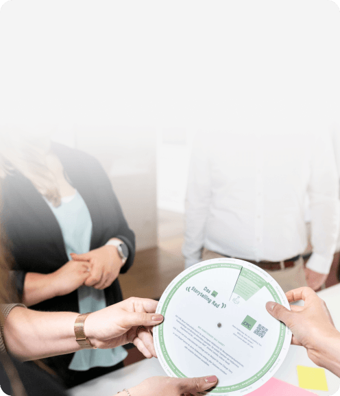 Workshop-Teilnehmende halten gemeinsam das „Storytelling Rad“, eine Drehscheibe der CPC